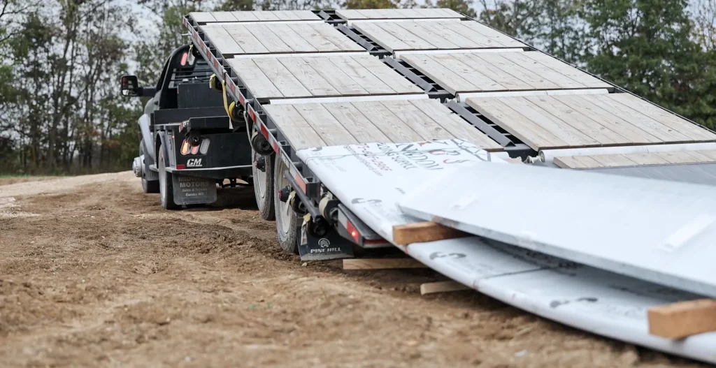 Delivery truck delivering metal to jobsite